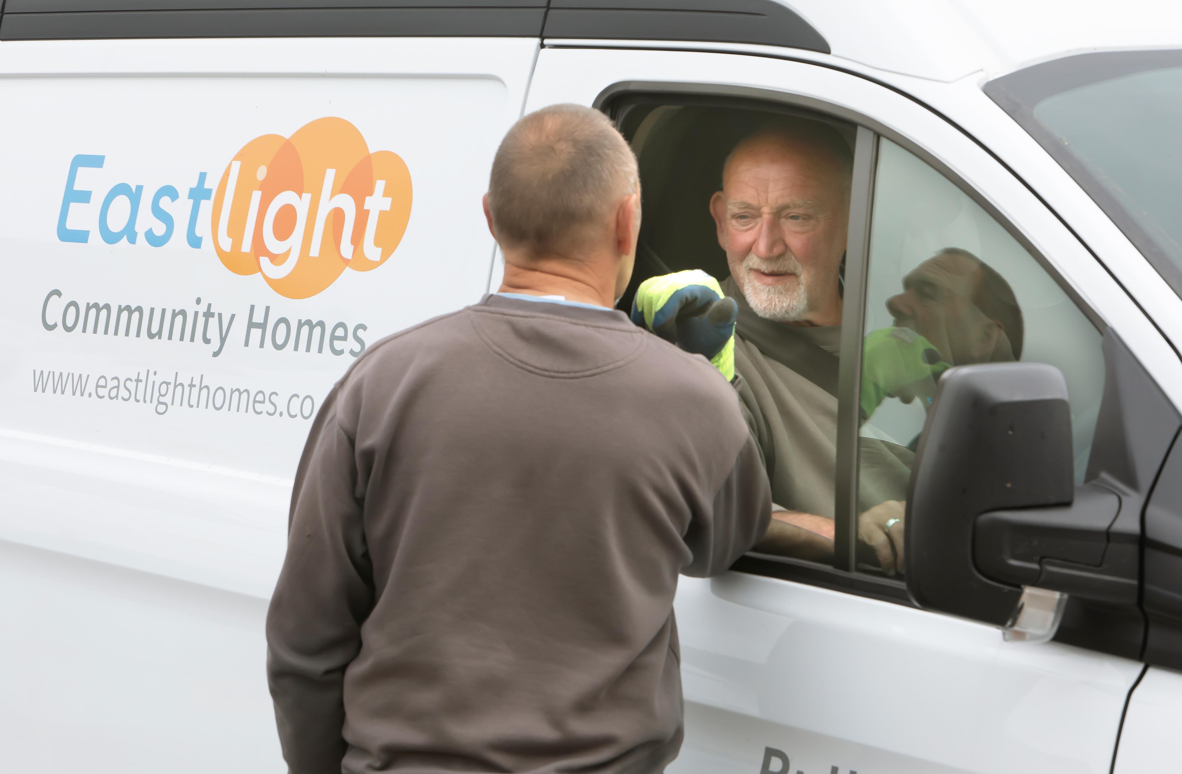 Estate Ranger, Marc, is sitting in the drivers seat of an Eastlight van. He is talking to a man who is standing outside the van.