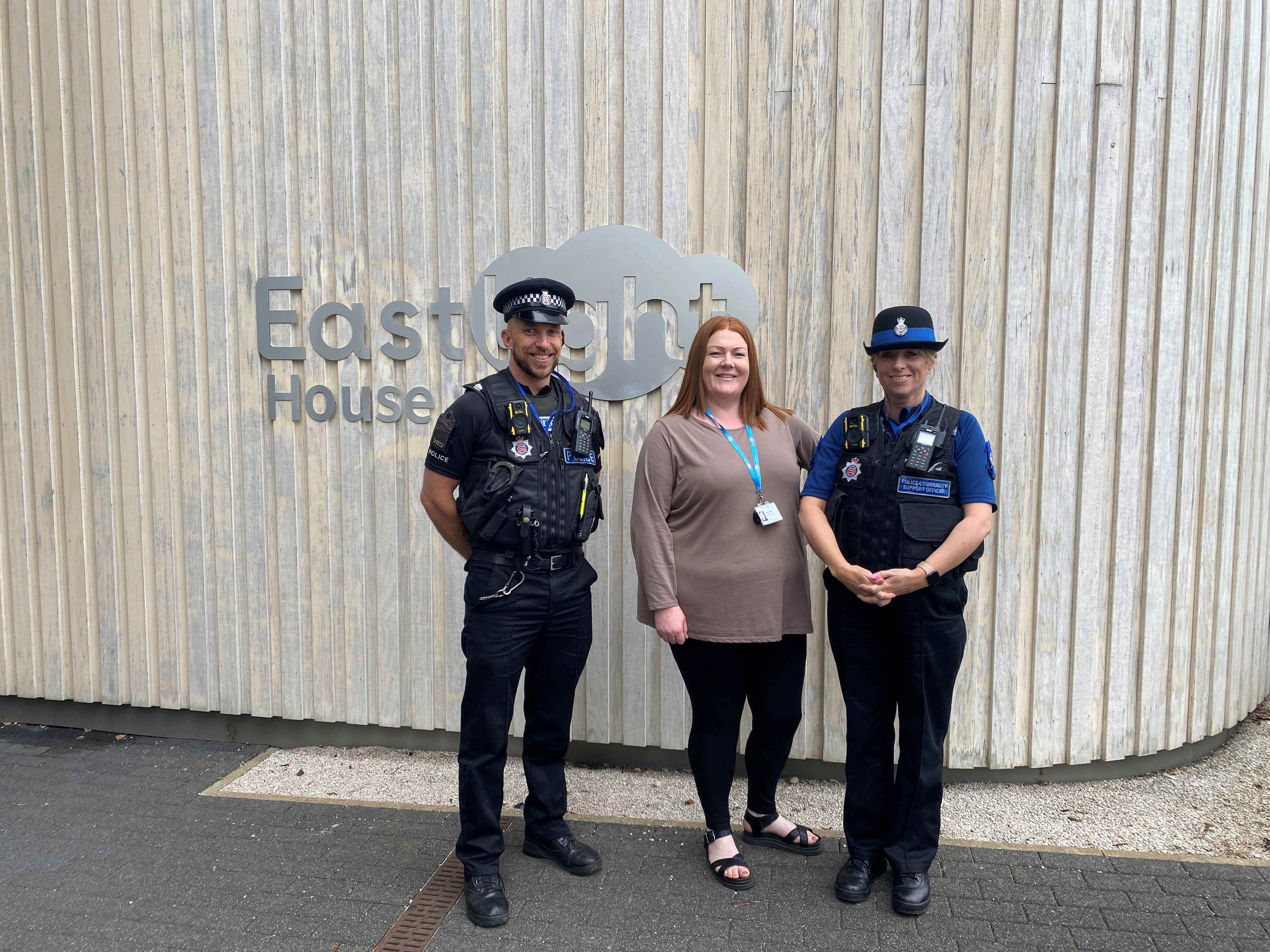 An Eastlight member of staff is stood in the middle of two Police officers.