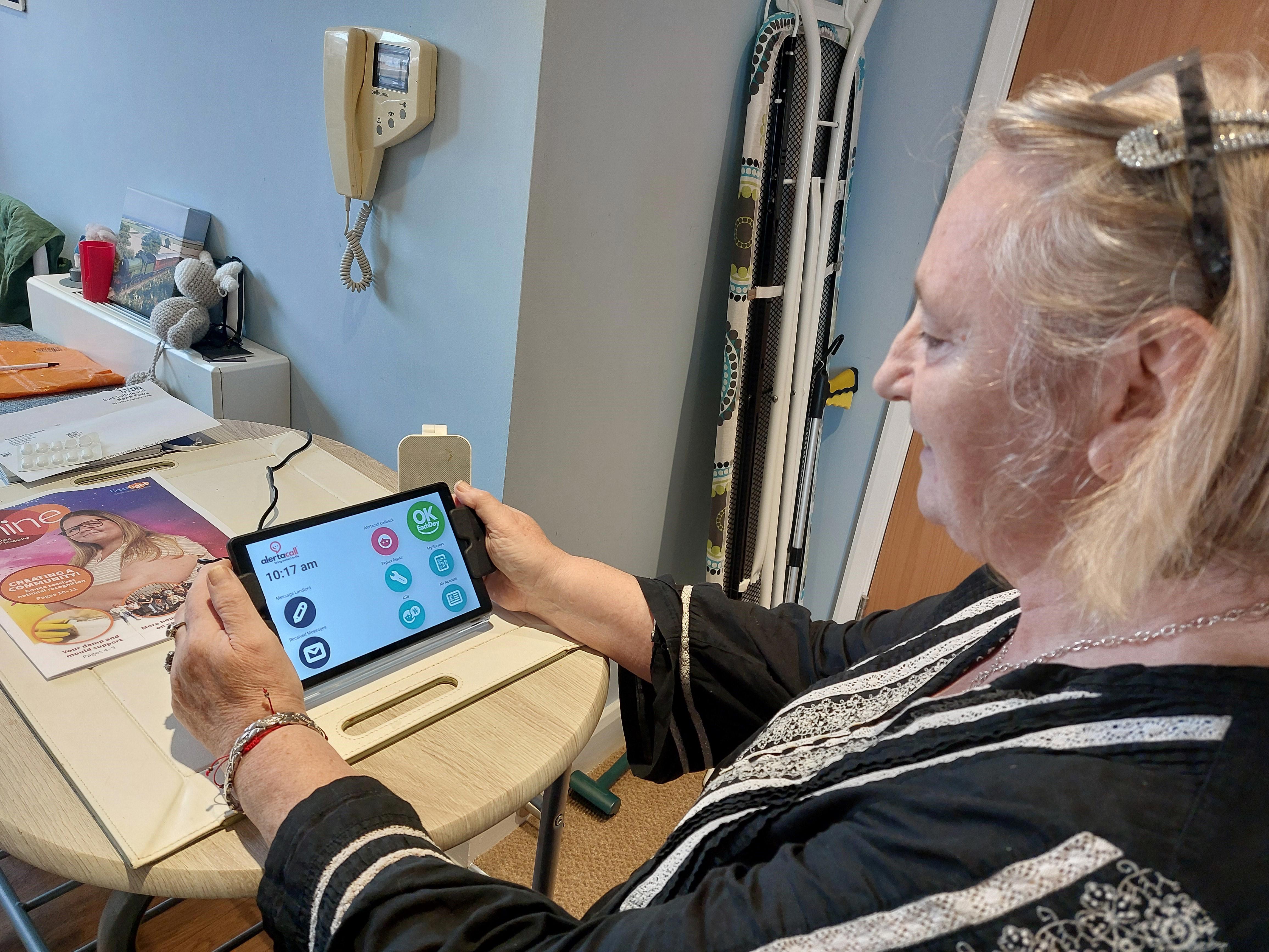 A woman is holding a rectangle shaped technology tablet.