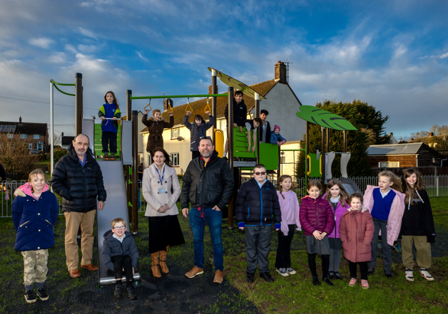 A group ofBraintree District Councillor, Diana Garrod, Steeple Bumpstead Parish Councillor and Chairman, Kerry Barnes, Eastlight Estate Safety Officer, Mark Garnham, and local children at the opening of the new play park on North Crescent.