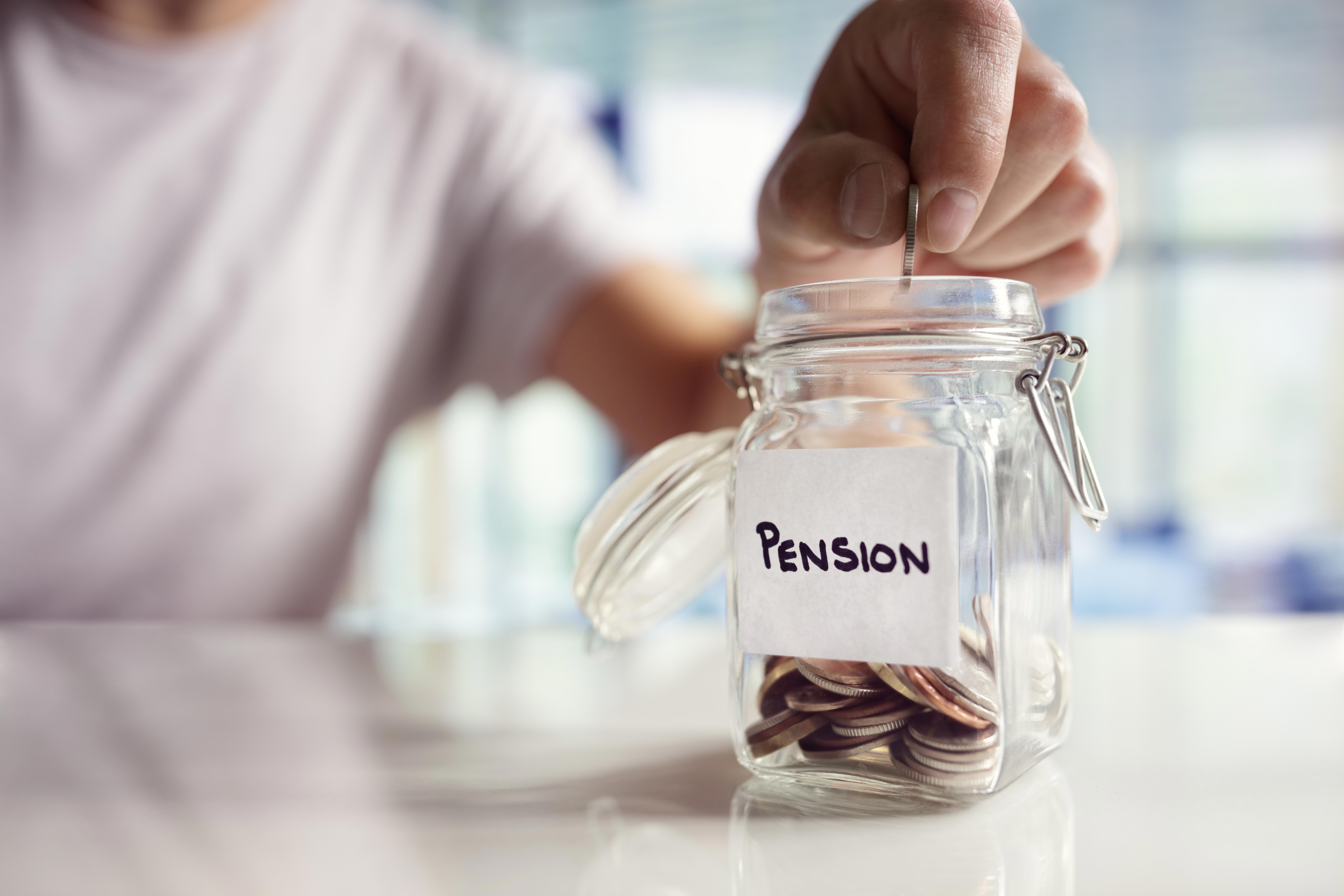 A glass jar with coins in is labelled 'Pension'.