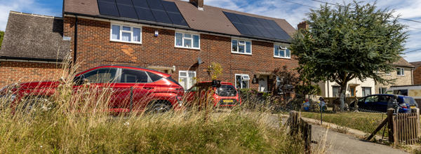 Two houses with solar panels on them.