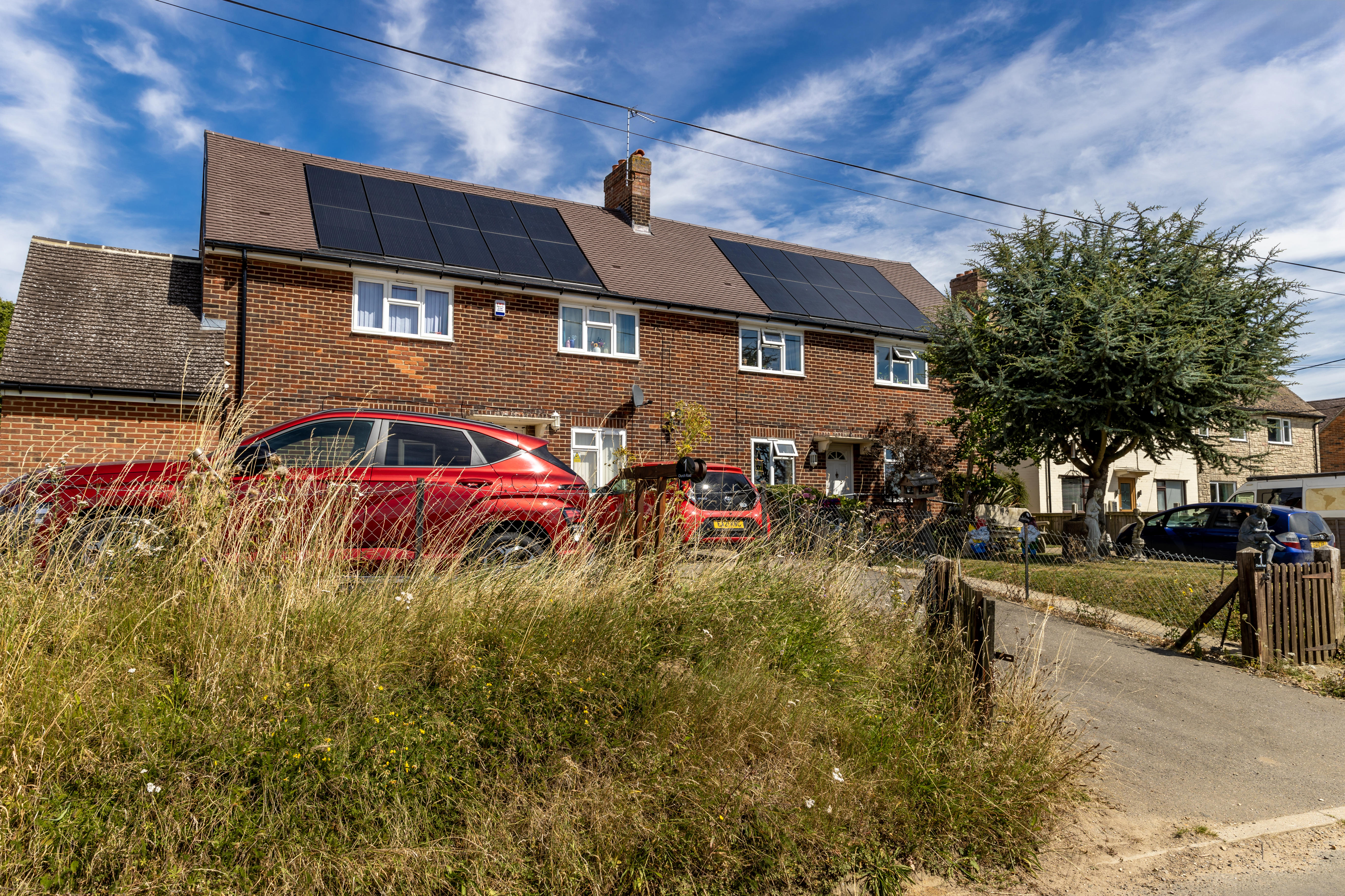 Two houses with solar panels on them.