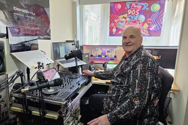 Dave Leslie is sat in front of his DJ Decks that he uses for his radio show on Storm FM.